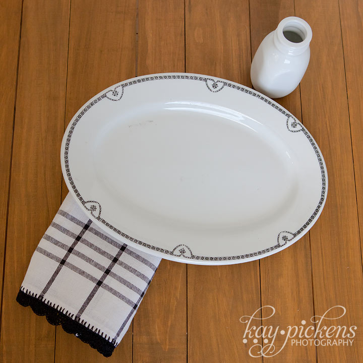 white dishes with black trim and matching tea towel