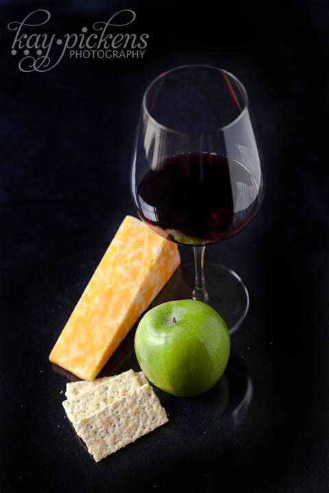 wine and cheese on black